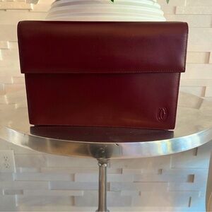 💯% Authentic Pristine Burgundy Cartier Clutch with built in wristlet strap.